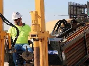 construction worker operating directional boring machinery