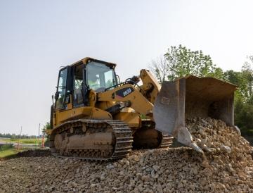 Dozer unloading rock