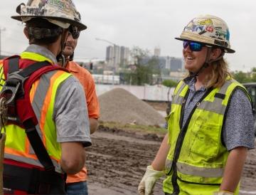 Three people talking while on a jobsite