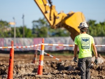 person standing in front of dig site