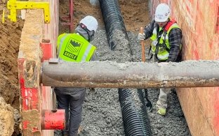Two construction workers in boring pit