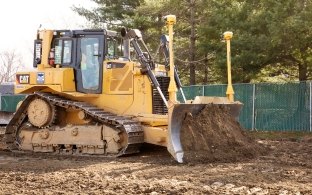 Yellow bulldozer pushing earth