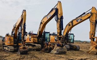 Three CAT excavators lined up on project site