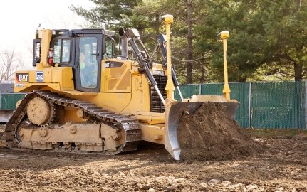 Yellow bulldozer pushing earth